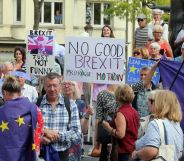 Protestors hold placards as they look on outside the venue for talks between the British Prime Minister and EU Commission president in Luxembourg. (FRANCOIS WALSCHAERTS/AFP/Getty Images)