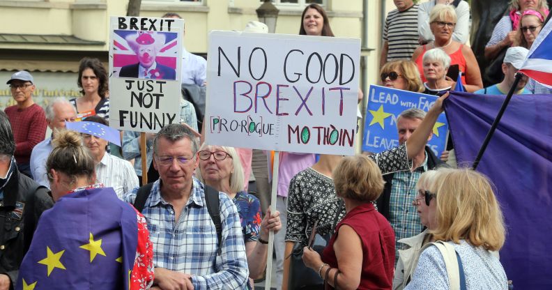 Protestors hold placards as they look on outside the venue for talks between the British Prime Minister and EU Commission president in Luxembourg. (FRANCOIS WALSCHAERTS/AFP/Getty Images)