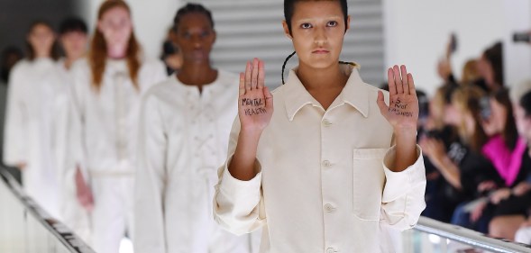 Non-binary model Ayesha Tan Jones protested mid-catwalk against Italian fashion house Gucci's use of straight jackets in its SS20 collection. (Jacopo Raule/Getty Images for Gucci)