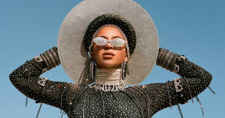 Beyoncé in Black is King wearing bejewelled sunglasses, a white wide-brimmed hat and a sparkly black body stocking