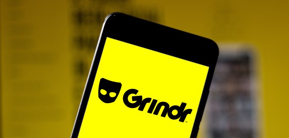 An iPhone with a Grindr splash screen