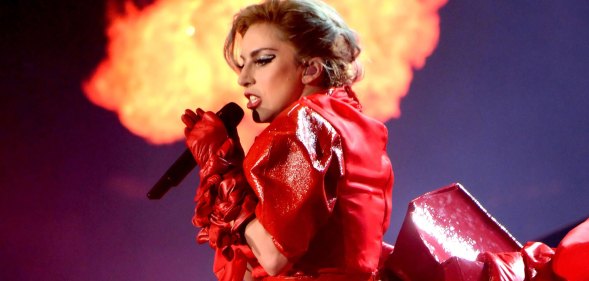 Lady Gaga in red leather infront of a column of flames