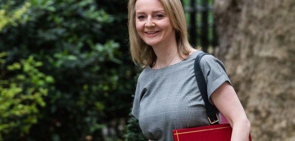 Liz Truss holding a red portfolio box