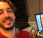 Gay radio host Seth Dunlap speaking into a radio microphone