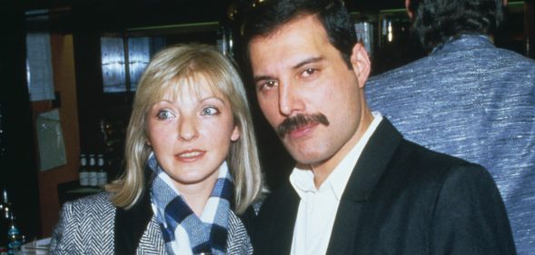 Singer Freddie Mercury (1946 - 1991) of Queen attends Fashion Aid at the Royal Albert Hall in London, with Mary Austin, 5th November 1985. (Dave Hogan/Getty Images)