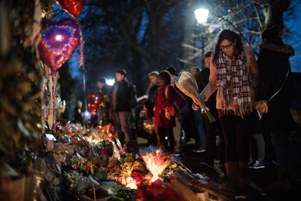 A woman lays flowers among tributes outside the home of pop music icon George Michael in The Grove, Highgate on December 28, 2016 in London, England. (Photo by Jack Taylor/Getty Images)