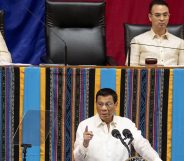 Philippine President Rodrigo Duterte gestures as he delivers his state of the nation address, as Senate President Vicente Sotto the III (top L) and House Speaker Alan Peter Cayetano (top R) look on at Congress. (NOEL CELIS/AFP via Getty Images)