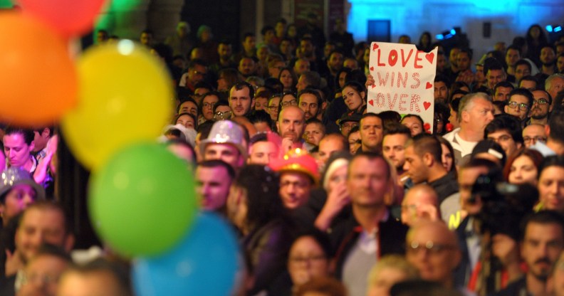 People gather to celebrate in Saint George's Square after the Maltese parliament approved a civil unions bill in Valletta on April 14, 2014. (Matthew Mirabelli/AFP via Getty Images)