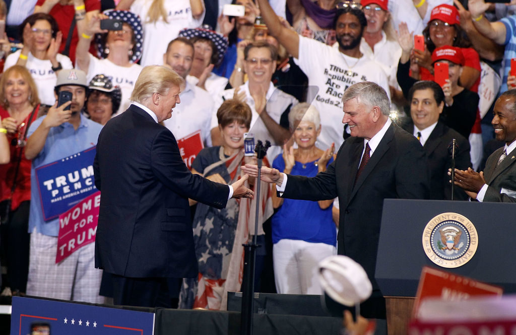 Franklin Graham with US President Donald Trump during a Trump rally on August 22, 2017 in Phoenix, Arizona.