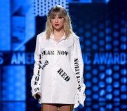 Taylor Swift wearing a shirt with the names of her first six albums at the AMAs