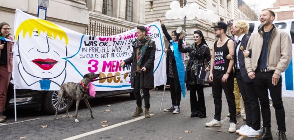 Members of LGBTQ community stage a 'marriage' between three men and a dog during a protest against Boris Johnson