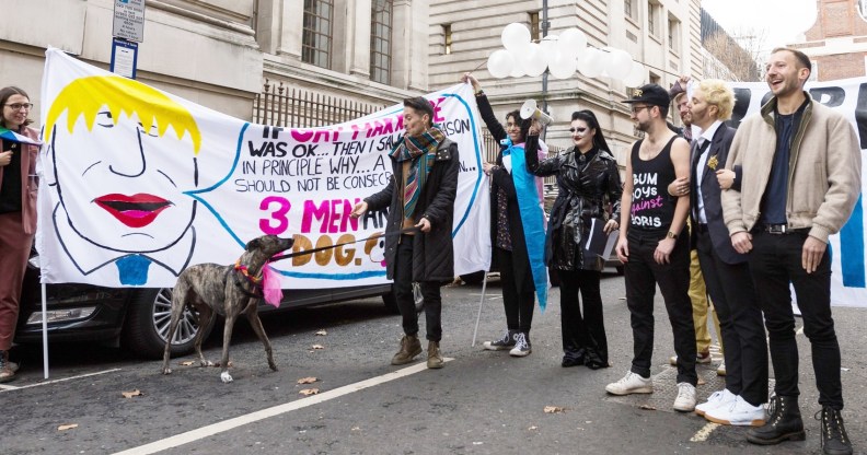 Members of LGBTQ community stage a 'marriage' between three men and a dog during a protest against Boris Johnson