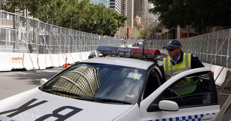 SYDNEY, AUSTRALIA - SEPTEMBER 06: A policeman gets into a police car, parked between security fences, on September 6, 2007 in Sydney, Australia. (Amos Aikman/Getty Images)