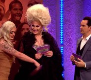 Baga Chipz wafting a card over The Vivienne's crotch as Jimmy Carr looks on