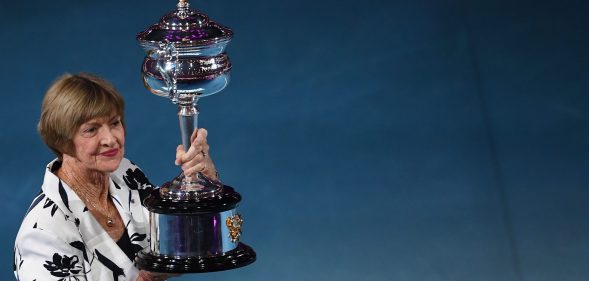 Former Australian tennis player Margaret Court poses with a replica of the trophy to commemorate 50 years of her Australian grand slam win