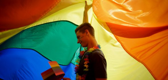 Participant dances as he holds up a large rainbow flag during the third Prague Pride March on August 17, 2013 in Prague, Czech Republic. (Matej Divizna/Getty Images)