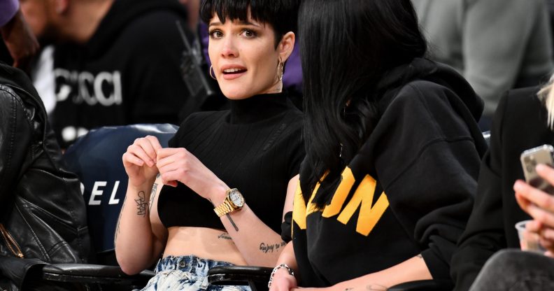 Halsey at a basketball game, looking worried