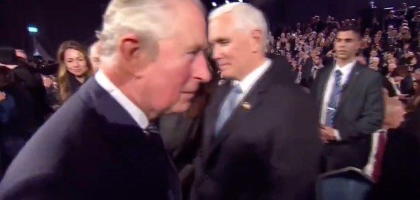 Prince Charles walking past Mike Pence