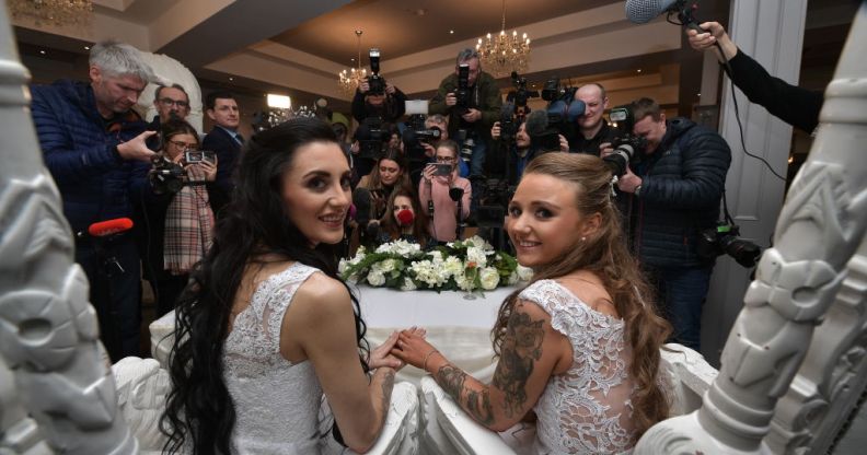 Robyn Peoples, from Belfast, and Sharni Edwards, from Brighton, pose for the media after getting married on February 11, 2020 in Carrickfergus, Northern Ireland.