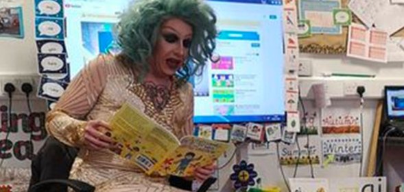 Drag queen story time performer Flowjob reading a book in a classroom