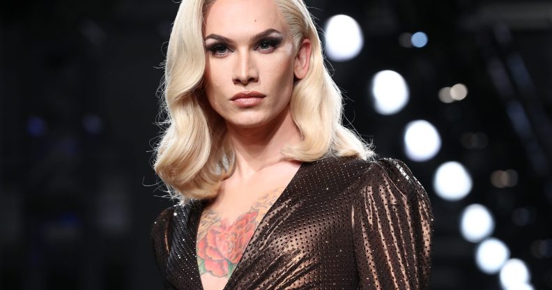 Miss Fame in a bronze metallic dress