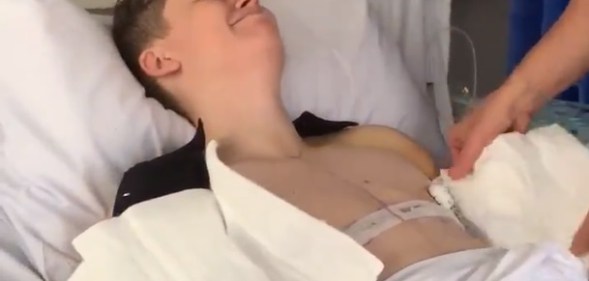 The powerful clip shows bandages being carefully removed in hospital after top surgery.