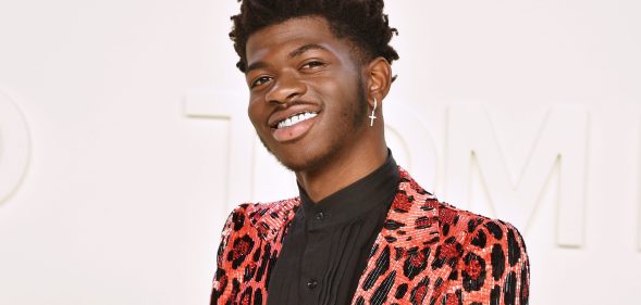 Lil Nas X in an orange leopard print suit