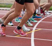 Women line up to sprint on a running track