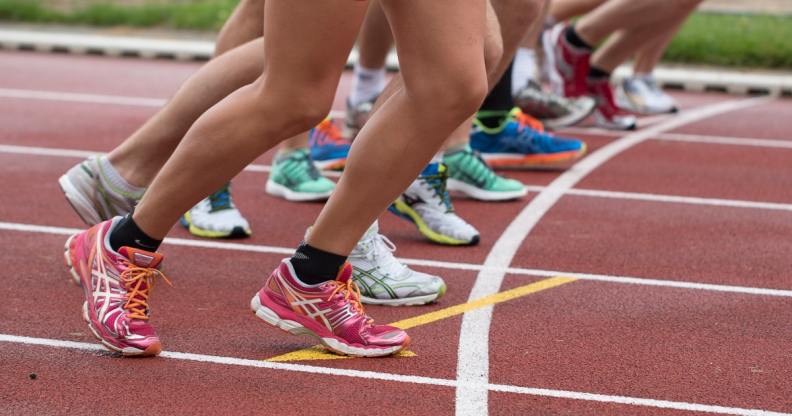 Women line up to sprint on a running track