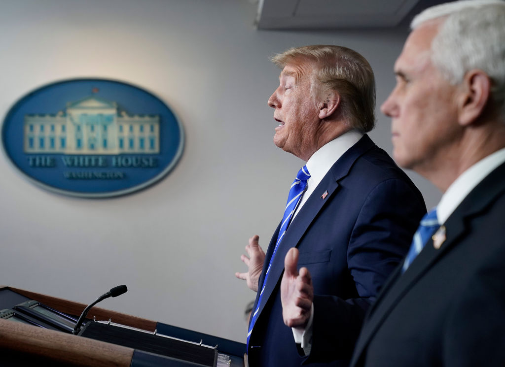 Flanked by Mike Pence, President Donald Trump speaks during daily briefing of the coronavirus task force at the White House.