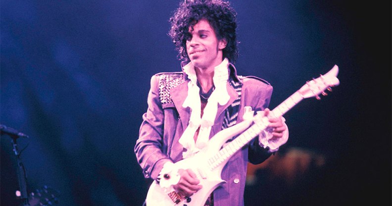 Prince performing on stage during his Purple Rain tour.