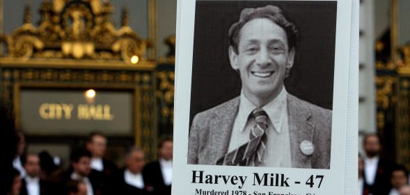 An attendee holds a picture of Harvey Milk at a memorial event marking 30th anniversary of killings of George Moscone and Harvey Milk at City Hall in San Francisco, California. (Mark Constantini/San Francisco Chronicle via Getty Images)