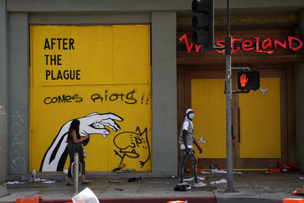 People walk past a store in downtown Santa Monica on May 31, 2020 in Los Angeles, California.. (Warrick Page/Getty Images)