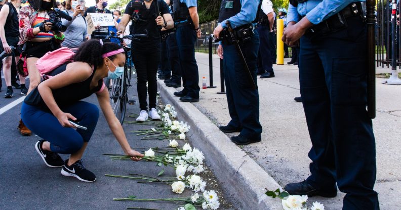 Protesters lay flowers at the feet of Chicago Police Department officers on June 06, 2020 in Chicago, Illinois.