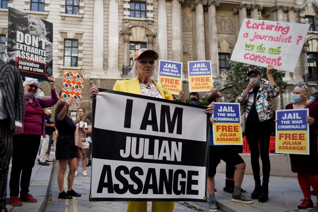 Vivienne Westwood gestures after being being suspended inside a ginat bird-cage in front Of the Old Bailey. (Niklas HALLE'N / AFP) (Photo by NIKLAS HALLE'N/AFP via Getty Images)
