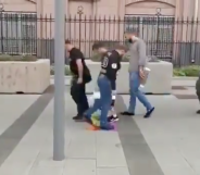 Russian straphangers took time out of their busy schedules to briefly queue up and wipe their feet on an LGBT+ Pride Flag. Classy. (Screen capture via Twitter)