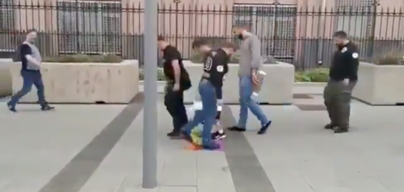 Russian straphangers took time out of their busy schedules to briefly queue up and wipe their feet on an LGBT+ Pride Flag. Classy. (Screen capture via Twitter)