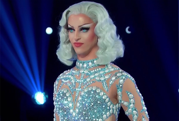 Miz Cracker in a blue wig and jewelled blue bodysuit