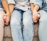 Three people hold hands in a closeup image