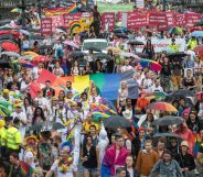 People hold placards and rainbow flags during a Pride event in Czech capital Prague on August 10, 2019