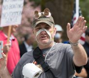 Man wearing a face mask cut out so that his mouth is exposed