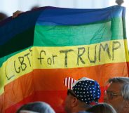 Supporters hold up an LGBT+ Pride flag for Republican presidential candidate Donald Trump. (George Frey/Getty Images