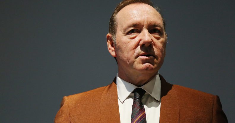 Kevin Spacey in an orange-brown suit