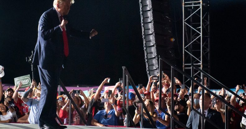 US President Donald Trump dances as he leaves a Make America Great Again rally as he campaigns at Orlando Sanford International Airport in Sanford, Florida, October 12, 2020.