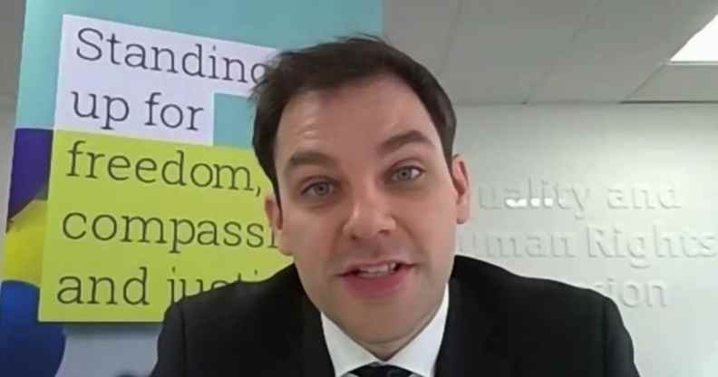 Alasdair Henderson speaking tot he camera with the EHRC signage behind him