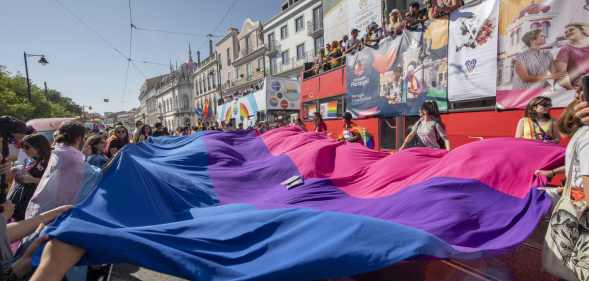 Participants display a bisexual pride flag during a 2019 pride parade in Lisbon, Portugal