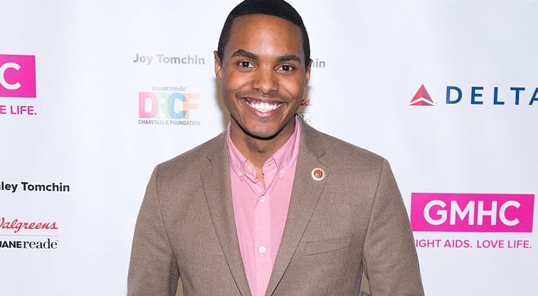 Out gay congressman Ritchie Torres in a brown suit jacket and pink shirt