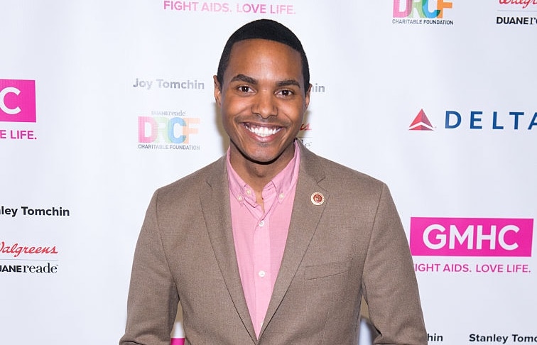 Out gay congressman Ritchie Torres in a brown suit jacket and pink shirt