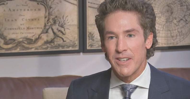 Joel Olsteen in a navy suit and printed tie