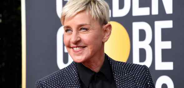 Ellen DeGeneres smile while wearing a grey suit jacket
